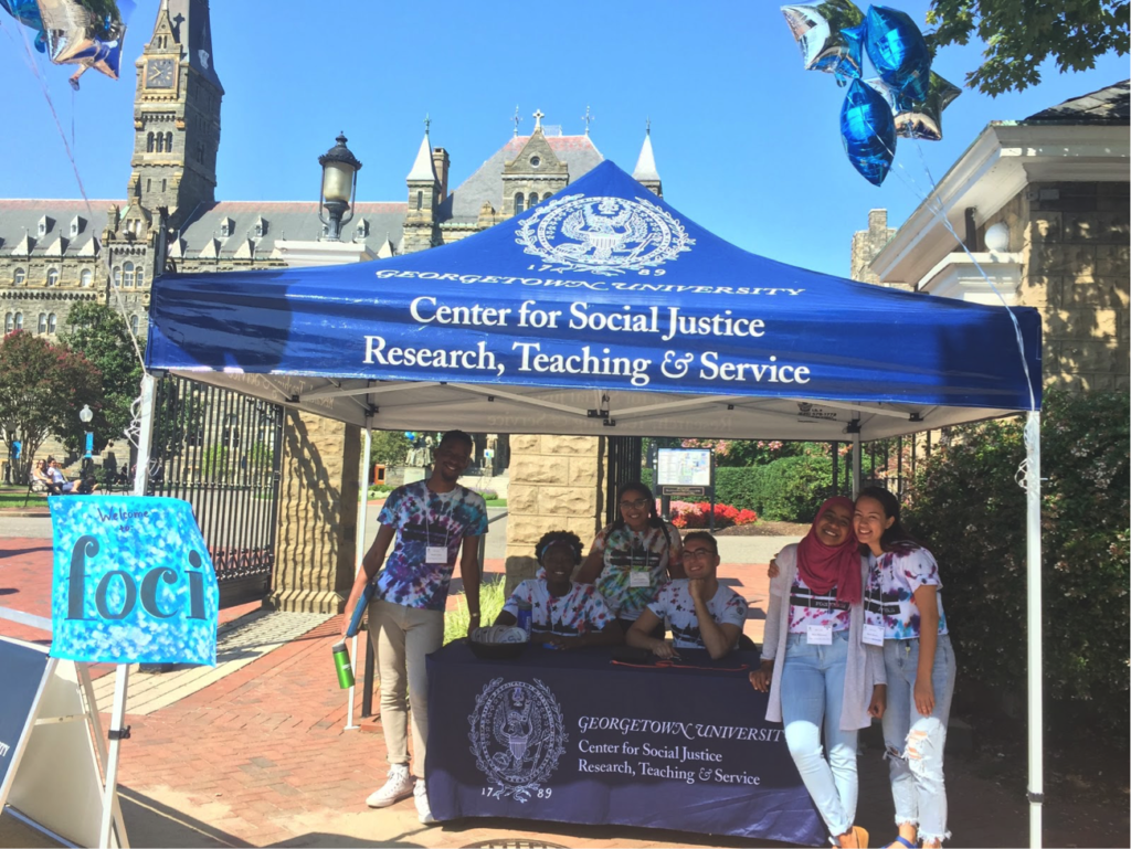 FOCI leaders under the CSJ tent at the Georgetown front gates share information on the program.