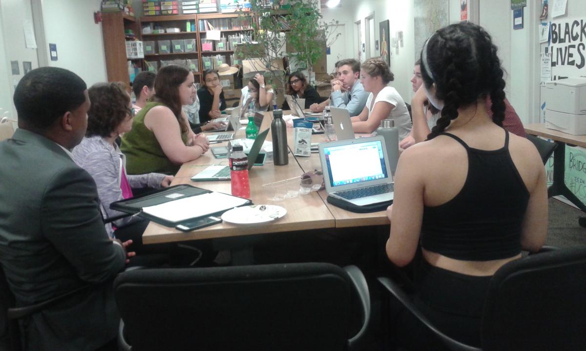 Students sit around a table