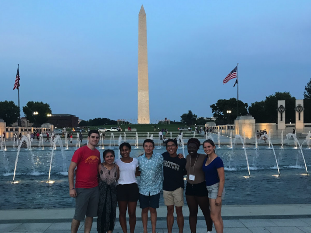 FOCI participants stand in front of the Washington monument during sunset.