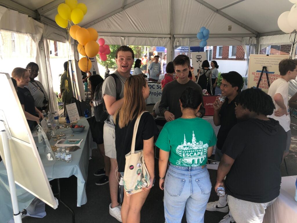 students gather at the CAB fair with students organizations tabling