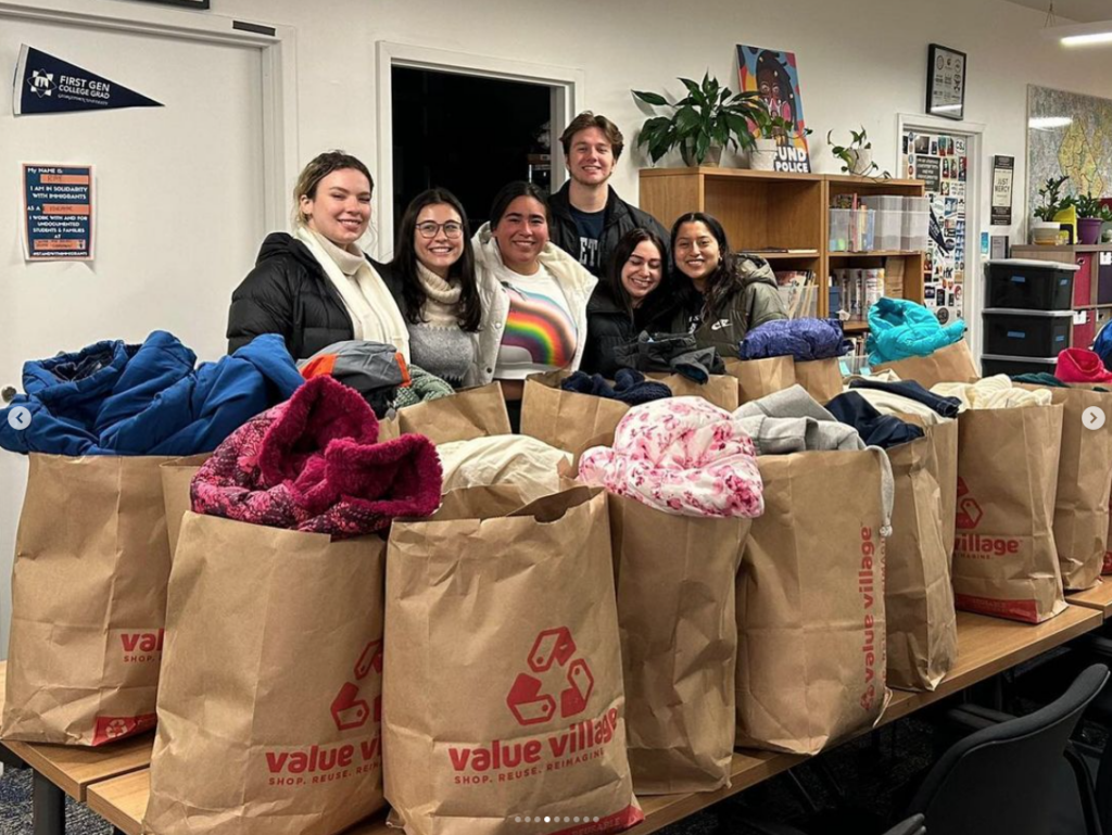 Students with bags of clothes for distribution