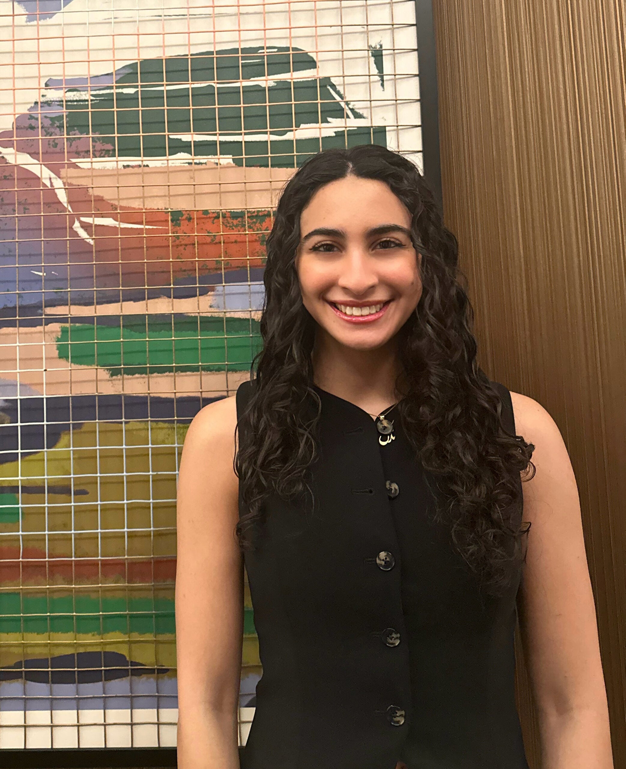 woman in black shirt smiling at camera