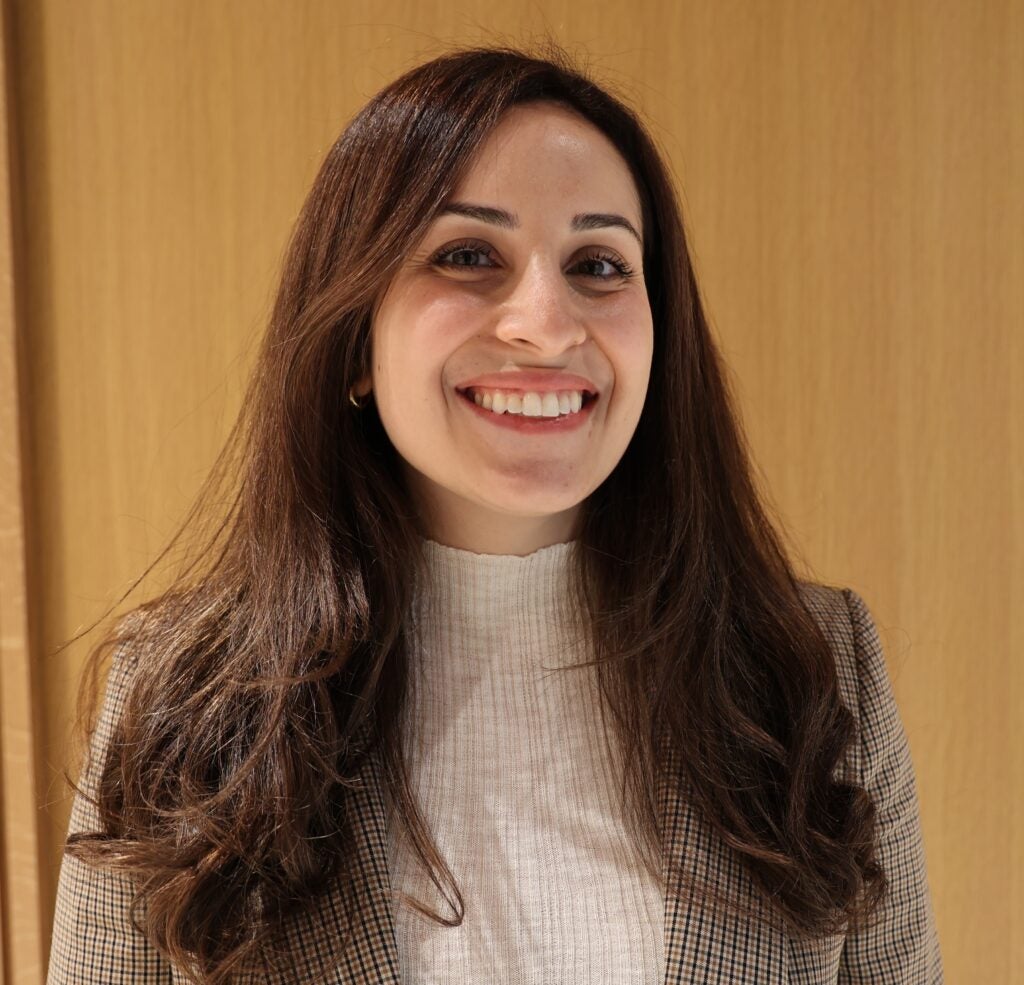 woman with long brown hair smiling at camera