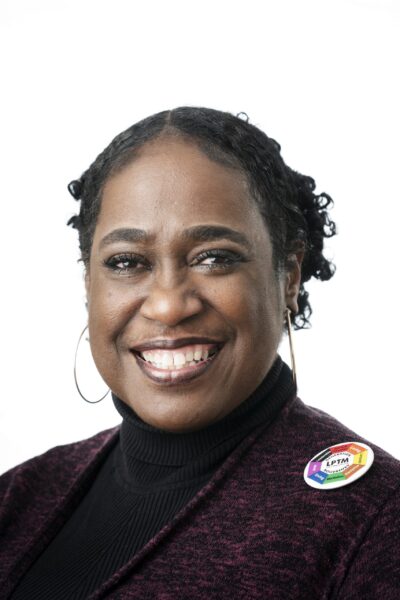 woman with hoop earrings smiling at camera