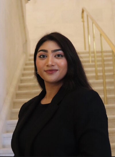 Woman with long dark hair lookign at the camera