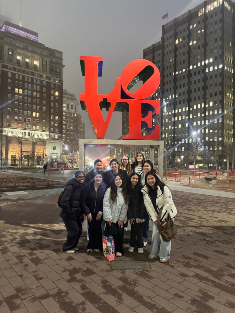 students standing in front of the LOVE sculpture